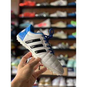 Green double couch with wooden legs