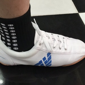 Green double couch with wooden legs