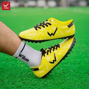 Green double couch with wooden legs