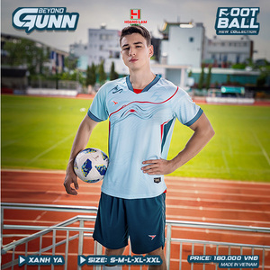 Green double couch with wooden legs