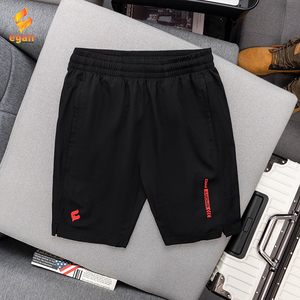 Green double couch with wooden legs