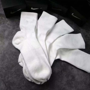 Green double couch with wooden legs